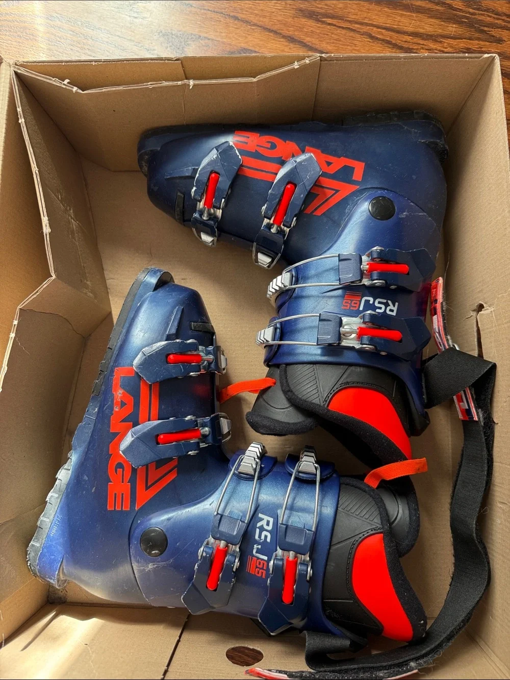 Lange Kids Blue Ski Boots with Orange Pull Tabs